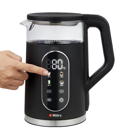 Black electric kettle with digital display and hand pointing at the display, on a white background.