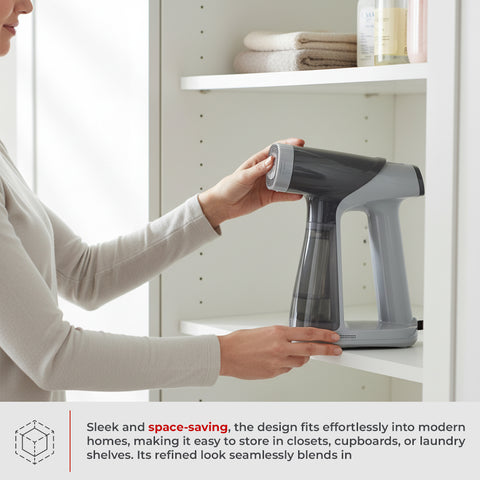 Person holding a gray handheld steamer in a bathroom setting