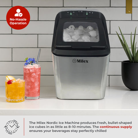 Milex Nordic ice machine with ice cubes visible, surrounded by drinks and a plant on a kitchen counter.