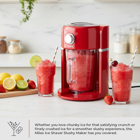Red Milex ice shaver slushy maker with two glasses of red slushie on a kitchen counter.