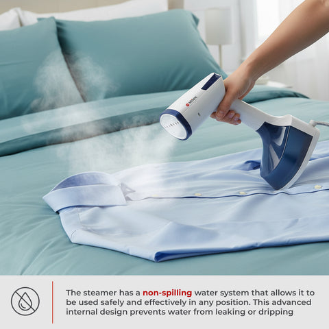 Person using a handheld steamer on a shirt on a bed with text about the steamer's non-spilling water system.