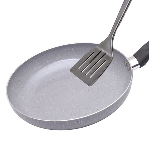 Gray speckled frying pan with a slotted spatula on a white background