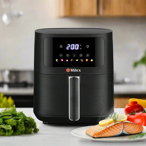 Milex 5.5L Compact Air Fryer with digital display on a kitchen counter, surrounded by fresh vegetables and food.