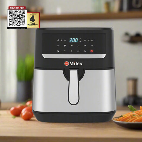 Milex air fryer on a kitchen counter with vegetables and a QR code for warranty information.