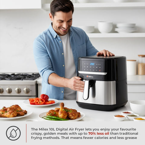 Man using a Miele 10L Digital Air Fryer in a kitchen with plates of food.